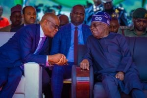 Nyesom Wike exchanging pleasantries with Bola Tinubu during an event