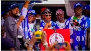 Christopher Imumolen raising the hand of APC governorship candidate, Bola Oyebamiji.