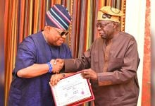 Ademola Adeleke presents his 2026 gubernatorial certificate of return to President Bola Tinubu
